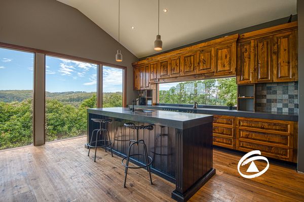 Semi-renovated kitchen with mountain views through ceiling to floor windows